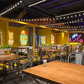 Modern Industrial Restaurant Interior With Graffiti Walls Metal Tables And Neon Lights