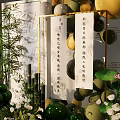 Elegant Event Decor Setup With Green Yellow Balloons Green Plants And Wooden Chairs