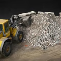 Yellow Loader At Construction Site With Rubble Pile And Large Stones