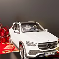 Art Installation Featuring White Mercedes SUV With Red Decorations Spheres Flowers And Golden Characters