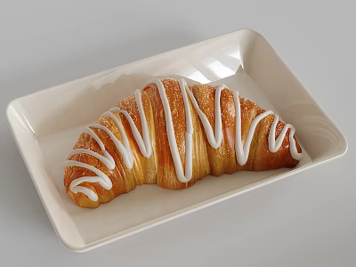 Freshly Baked Croissant With Drizzled White Icing On White Rectangular Plate 3d model