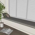 Decorative Pillows on Cozy Window Seat with White Blinds Green Plant and Open Magazine Nearby