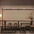 Wooden Dining Table with Stools Minimalist Wall Hanging Rack Floor Lamp Vase and Red Blossoms