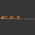 Three Orange Food Chunks Arranged On Wooden Cutting Board Surface