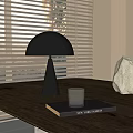 Minimalist Table Lamp With Black Shade On Wooden Table With Book Glass And Window Blinds