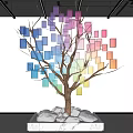 Colorful Square Tree Art Installation With Brown Trunk And White Stones
