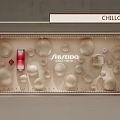 Shiseido Cosmetic Window Display With Red Bottle And Circular Decorations