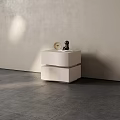 Modern Minimalist Bedside Table With Round Clock And Small Black Sculpture Against Light Colored Wall