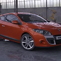 Orange Renault Megane Coupe in Industrial Garage Setting With Sleek Exterior Design