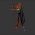 Vintage Wooden Camera with Red Tripod and Black Cloth Cover