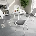 White Round Table with Four Grey Chairs by Window with Bookshelf and Green Plant