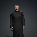 Bald Man Wearing Black Traditional Robe Standing Against Dark Gray Background