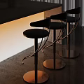 Modern Bar Stools With Black Padded Seats And Copper Metal Frames By Bar Counter