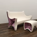 Modern Public Chair Featuring White Sleek Surface And Pink Patterned Accents With Matching Ottoman