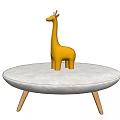 Yellow Wooden Giraffe Doll Placed On Round Beige Table With Thin Legs