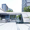 Contemporary Community Entrance Gate with Glass and Surrounding High Rise Buildings Green Plants Paved Square