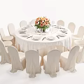 Elegant Round Dining Table Set With White Tablecloth Floral Centerpiece And White Chairs