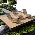 Tranquil Water Fountain Garden With Lounge Chairs Trees Stone Pathway Rocks And Water Lilies