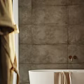 Modern Bathroom Interior with Gray Tiled Walls White Bathtub Hanging Robe Wooden Vanity Mosaic Shower