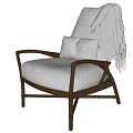 Comfortable Rattan Leisure Chair With Light Gray Cushion And Fringed Blanket For Cozy Home Use