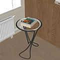 Round Side Table with Glass Top Metal Frame and Stack of Books Near Window