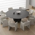 Modern Round Dark Gray Dining Table Set with Six Light Colored Chairs and Minimalist Decor