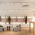 Modern Clothing Store Interior With Pink Walls Gray Sofas And Green Plants