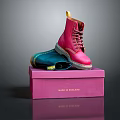 Pink Dr. Martens Boots On Pink Box With Blue Pair And Brand Logo