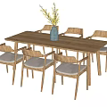 Wooden Dining Table Set With Six Chairs Padded Seats And Blue Vase Holding Yellow Flowers