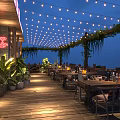 Cozy Outdoor Bar With Wooden Deck String Lights Green Plants And Neon Sign