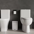 Modern Bathroom With Two White Toilets Small Trash Can And Brush Holder