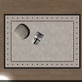Square Beige Rug With Black Border On Geometric Wooden Floor Featuring Magazine And Decorative Stone