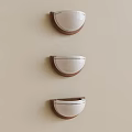 Three Modern Wall Sconces With White Shades And Wooden Frames On Light Wall