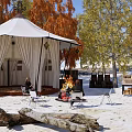 Scenic Campsite With White Tent Autumn Trees Tables Chairs And Sandy Ground