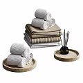 Cozy Home Living Essentials With Rolled Towels Stacked Blankets And Aromatherapy Reed Diffuser On Trays
