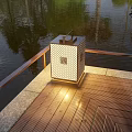 Outdoor Light With Square Lattice Design On Wooden Deck Near Water Surface And Railing