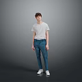 Young Man Standing In Gray Background Wearing White T Shirt And Blue Pants