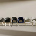 Modern Accent Chairs In Various Colors Arranged Against Wall For Living Room Decor