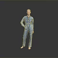 A Woman Standing Barefoot With Hands On Hips In Blue Denim Jumpsuit Against Gray Background