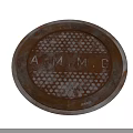 Road Facility Rusty Circular Metal Cover With A.M.M.G Letters And Metal Ring