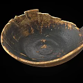 Ancient Pottery Bowl With Chipped Edges And Black Brown Textured Surface