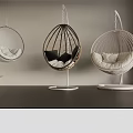 Three Stylish Hanging Chairs With Beige Black Cushions Woven Metal Frames In Modern Interior
