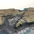 Stunning Natural Scenery With Brown Island Blue Coastal Waters And Rocky Landforms