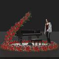 Floral Installation Surrounding Black Piano With Red And Pink Flowers And Woman Standing By