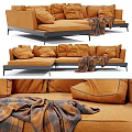 Cozy Orange Two Seater Sofa With Soft Cushions And Plaid Throw Blanket