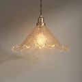 Warm Glowing Textured Glass Pendant Light With Scalloped Edges And Brass Ceiling Fixture