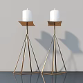Two Modern Candle Lamps With White Candles And Golden Triangular Stands On Dark Tabletop
