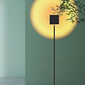 Modern Black Floor Lamp With Sleek Design And Soft Background Light Near Green Leaves