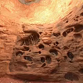 Natural Red Rock Interior With Sunlit Holes And Textured Stone Walls