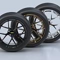 Three Automotive Tires With Black Gold Silver Rims And Different Designs